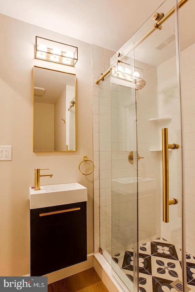 bathroom with a stall shower and vanity