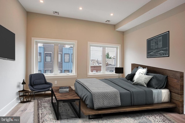 bedroom featuring recessed lighting, light wood-type flooring, visible vents, and baseboards