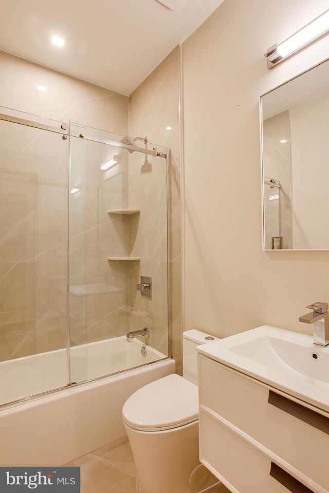 full bath with bath / shower combo with glass door, vanity, toilet, and tile patterned floors