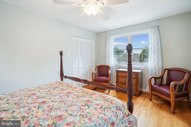 bedroom featuring a ceiling fan, a closet, and light wood-style flooring