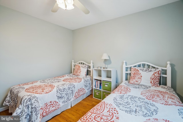 bedroom with a ceiling fan and wood finished floors