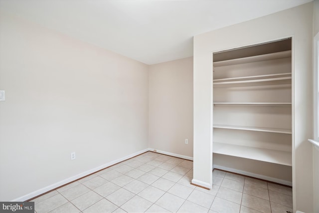 interior space with tile patterned flooring and baseboards