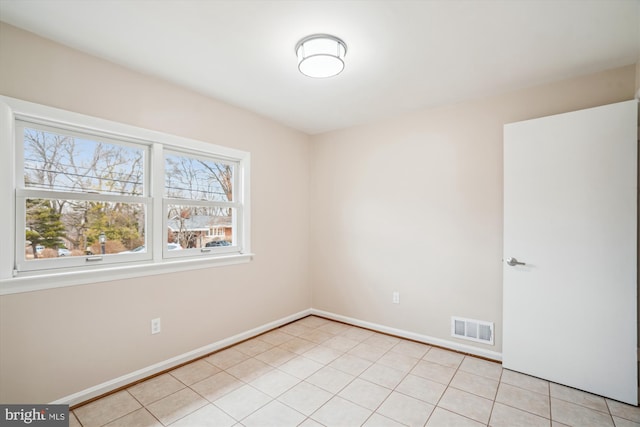 unfurnished room featuring visible vents, baseboards, and light tile patterned floors