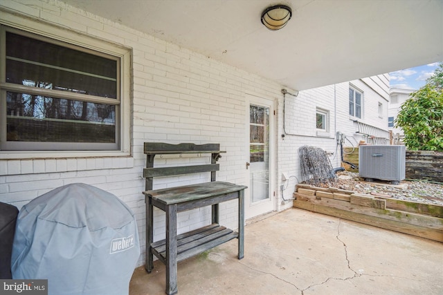 view of patio / terrace featuring grilling area and central air condition unit