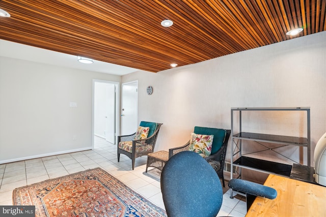 living area featuring baseboards, wood ceiling, and tile patterned floors