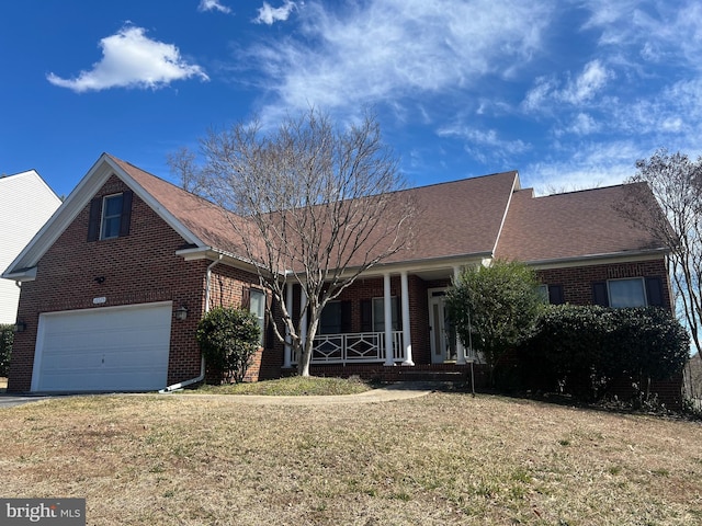 ranch-style home with a front lawn, brick siding, covered porch, and driveway