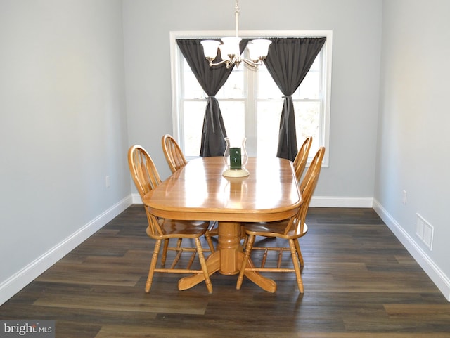 dining space with a notable chandelier, visible vents, baseboards, and dark wood-style flooring