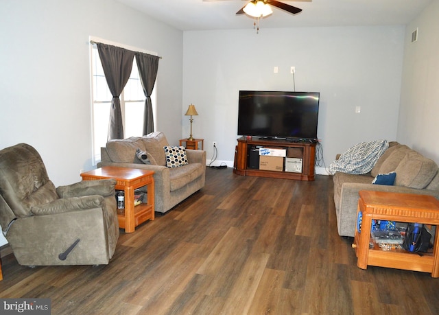 living room with ceiling fan, visible vents, and dark wood finished floors