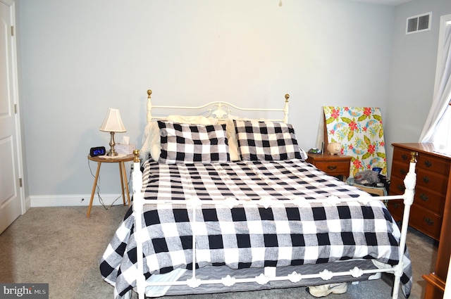 bedroom with light carpet, visible vents, and baseboards