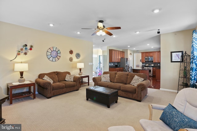 living area with recessed lighting, baseboards, a ceiling fan, and light colored carpet