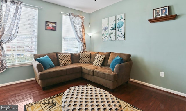 living area with wood finished floors and baseboards