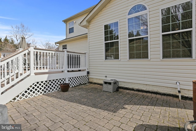 view of home's exterior with a patio and a wooden deck