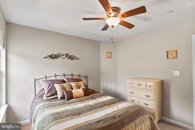 carpeted bedroom featuring ceiling fan and baseboards