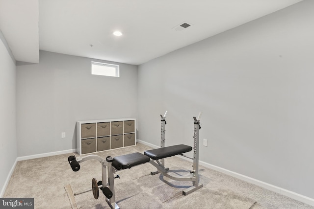 workout area with carpet, visible vents, and baseboards