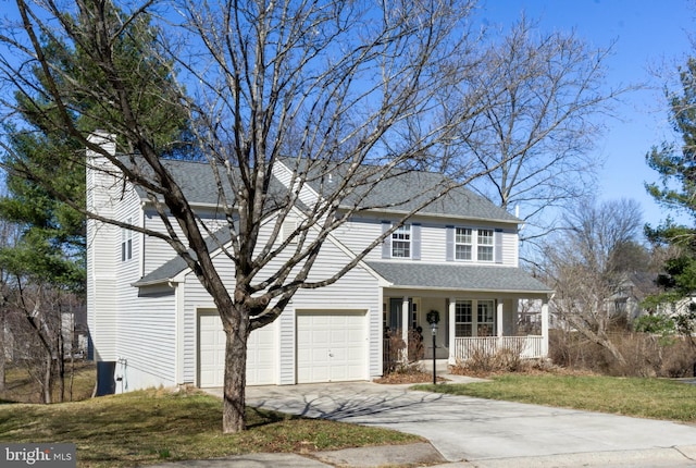 traditional-style house featuring a porch, a shingled roof, driveway, and a front lawn