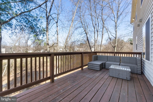 wooden terrace with an outdoor living space