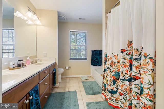 bathroom with tile patterned floors, visible vents, toilet, and a sink