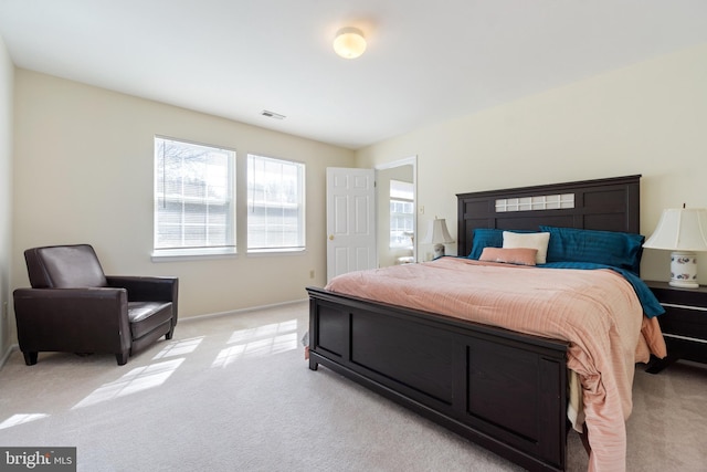 bedroom with visible vents and light carpet