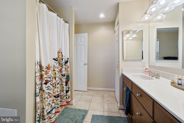 bathroom with tile patterned flooring, vanity, and baseboards