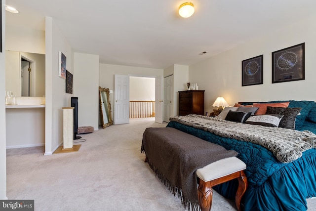 bedroom with visible vents, carpet floors, and baseboards