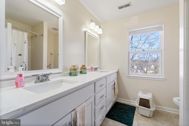 bathroom with a sink, visible vents, toilet, and tile patterned flooring