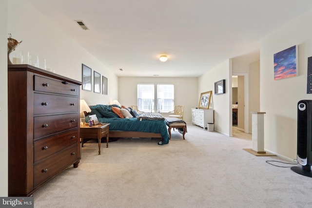 bedroom featuring baseboards, visible vents, and light carpet