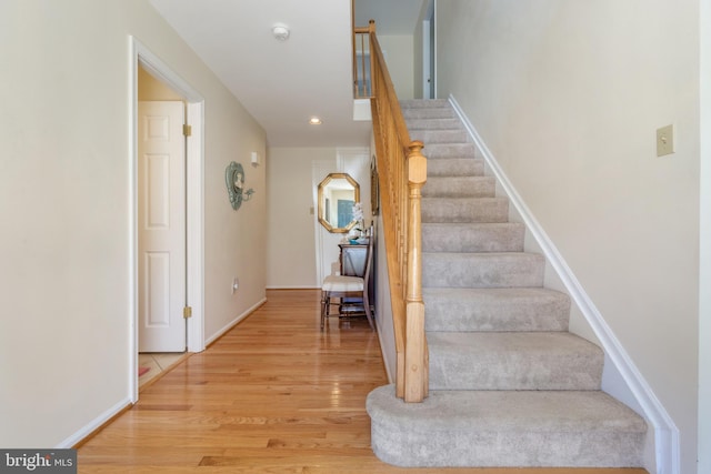 stairs featuring recessed lighting, wood finished floors, and baseboards