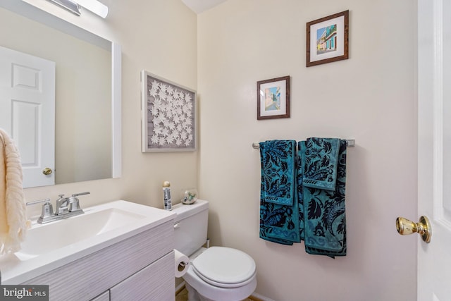 bathroom featuring toilet and vanity