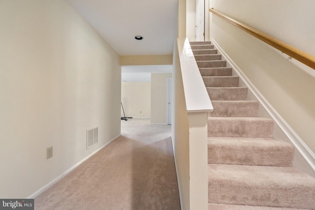 stairway featuring carpet flooring, baseboards, and visible vents