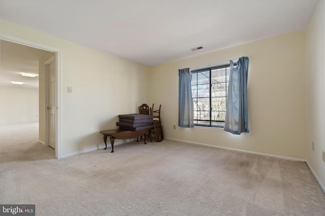 interior space featuring visible vents, carpet floors, and baseboards