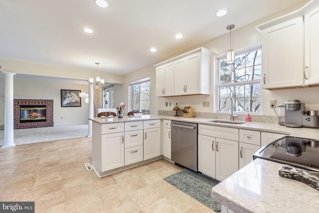 kitchen featuring white cabinetry, a peninsula, a sink, stainless steel dishwasher, and open floor plan