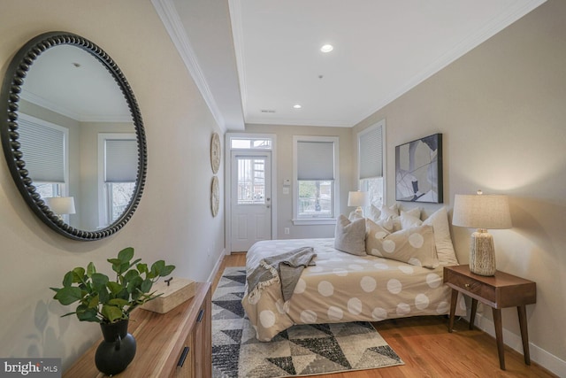 bedroom featuring baseboards, recessed lighting, wood finished floors, and crown molding