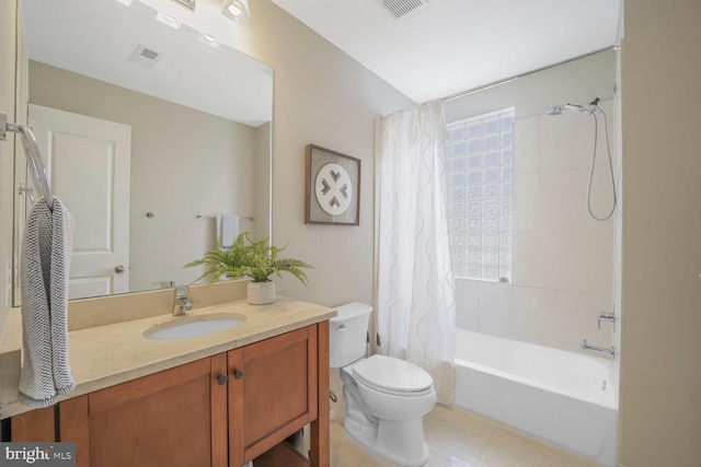 bathroom featuring visible vents, toilet, tile patterned flooring, shower / bath combo with shower curtain, and vanity