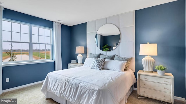 bedroom featuring visible vents, baseboards, and light colored carpet