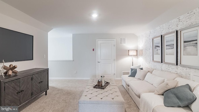 living room with light colored carpet, visible vents, and baseboards