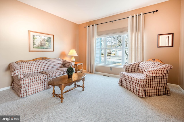 carpeted living room featuring visible vents and baseboards