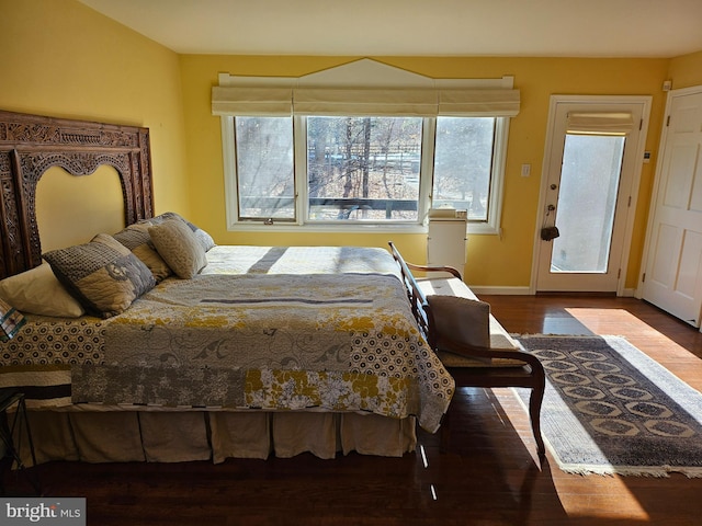 bedroom featuring baseboards and wood finished floors