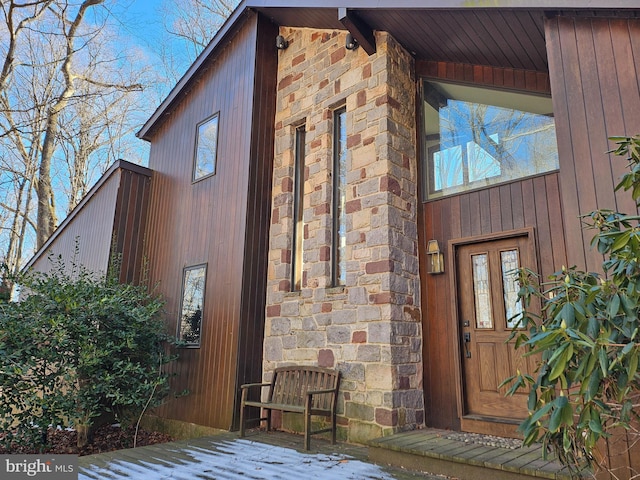 property entrance with stone siding