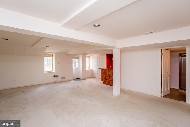 basement with carpet flooring, baseboards, and visible vents