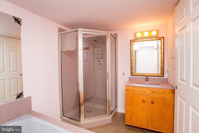 bathroom featuring vanity, a shower stall, a bath, and tile patterned flooring