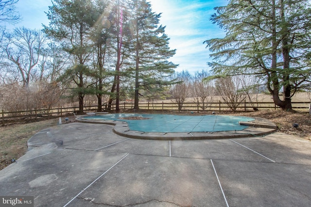 view of swimming pool with a patio area, fence, and a fenced in pool