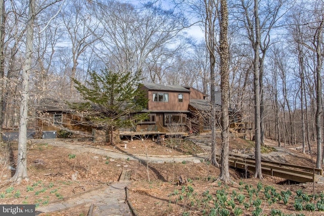 back of property featuring a shingled roof