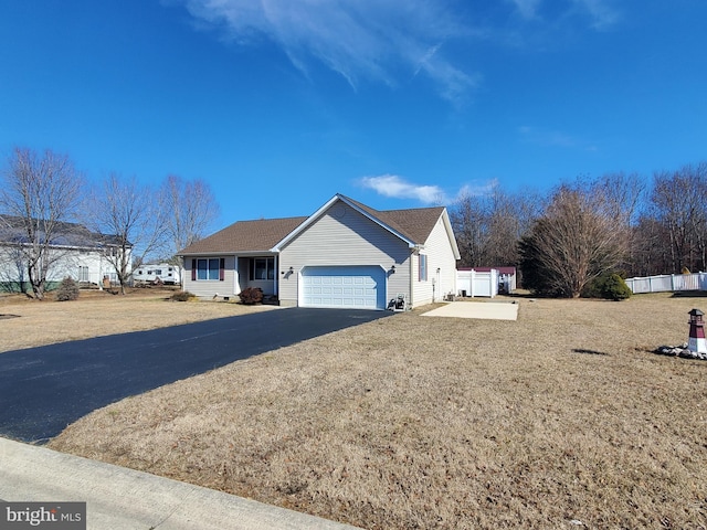 ranch-style house featuring driveway, a garage, and a front yard