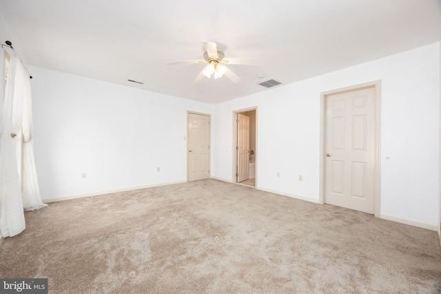 unfurnished bedroom featuring carpet floors, baseboards, visible vents, and a ceiling fan