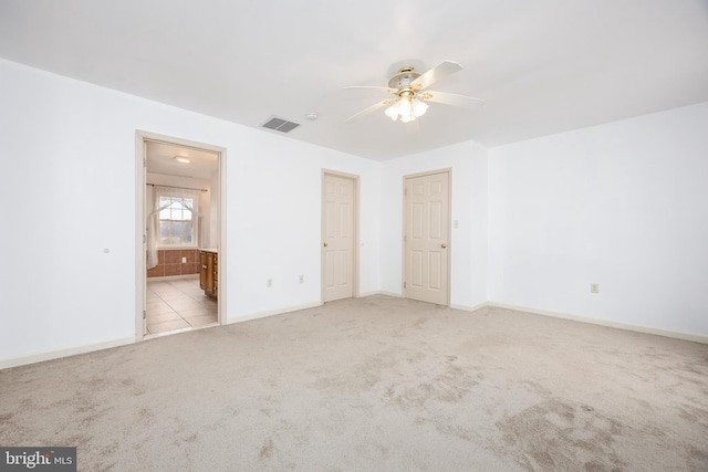 unfurnished bedroom with carpet, connected bathroom, and baseboards