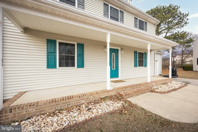 view of exterior entry with covered porch