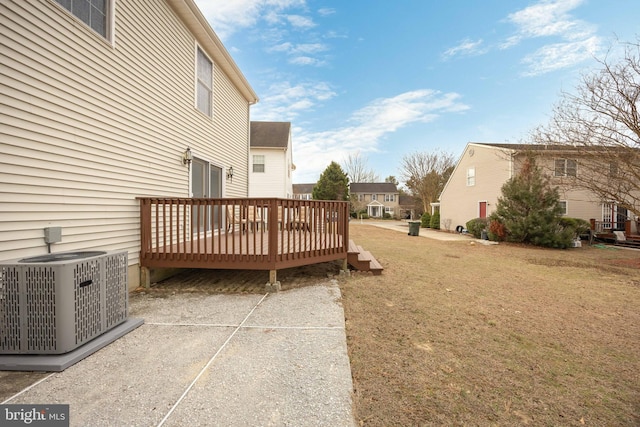 view of yard featuring a deck and central air condition unit