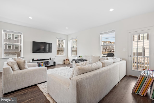 living area featuring baseboards, dark wood finished floors, and recessed lighting