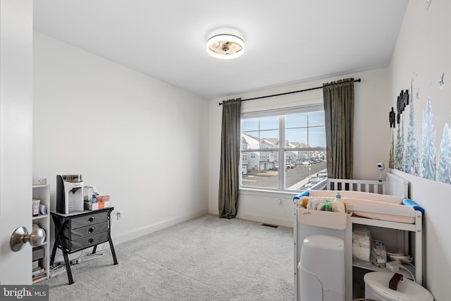 carpeted bedroom featuring visible vents and baseboards