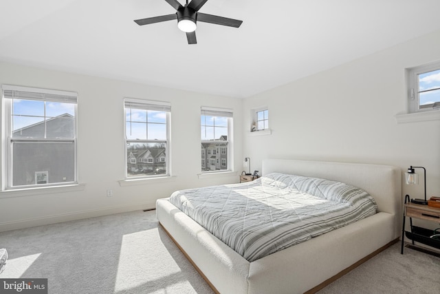 bedroom featuring multiple windows, carpet flooring, and baseboards